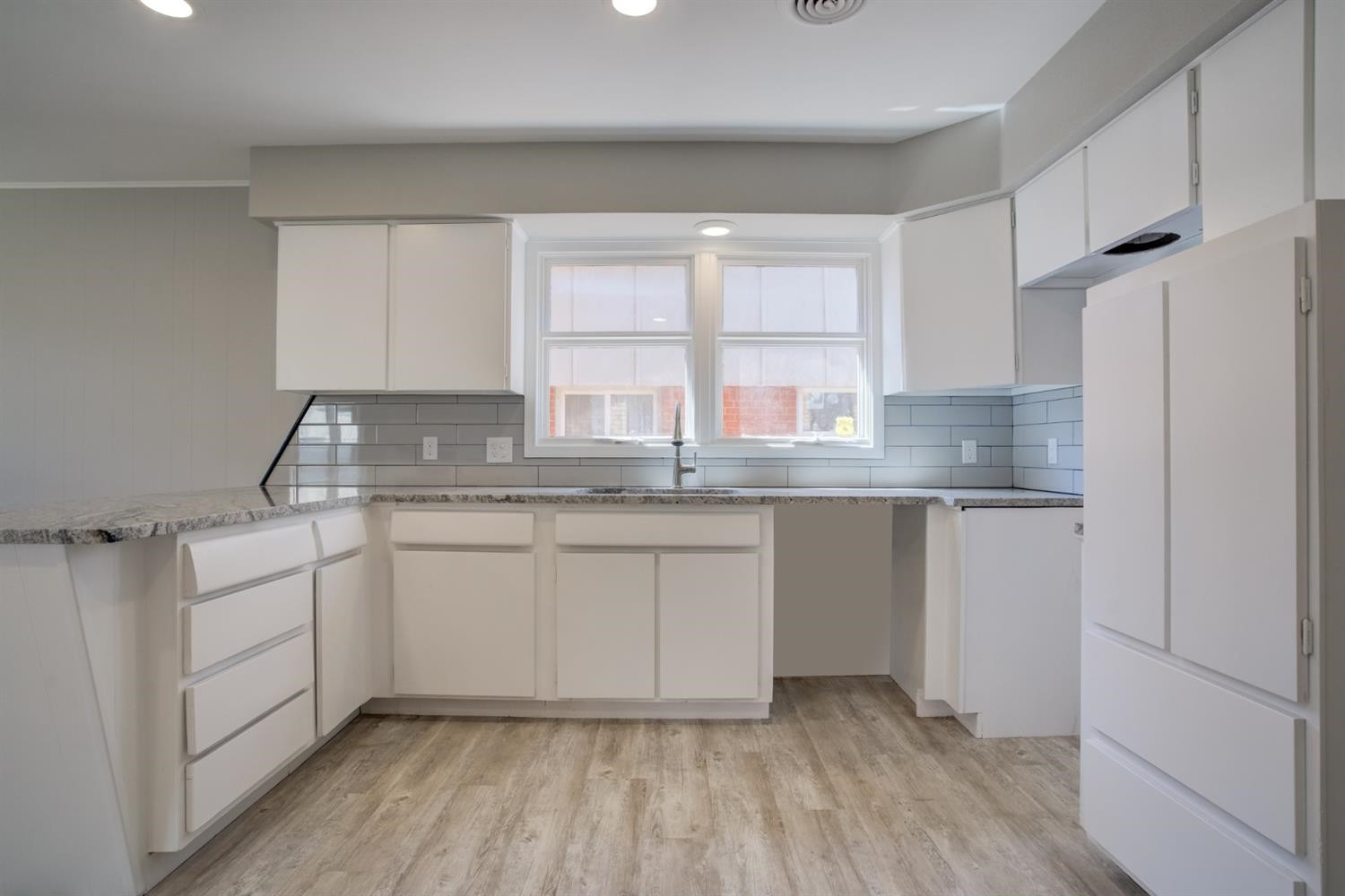 2113 66th Street Lubbock, TX 79412 - Photo 17 of 44 a kitchen with granite countertop cabinets stainless steel appliances a sink and a window