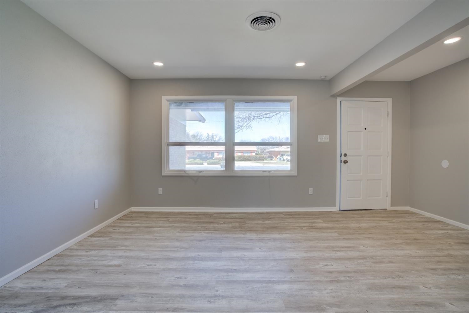 2113 66th Street Lubbock, TX 79412 - Photo 23 of 44 wooden floor in an empty room with a window