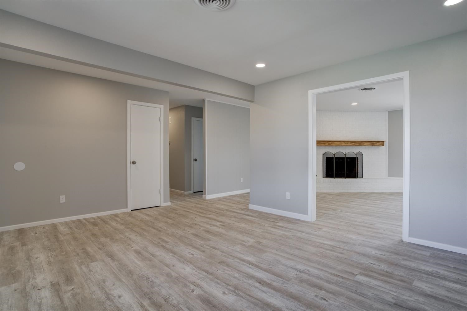 2113 66th Street Lubbock, TX 79412 - Photo 25 of 44 a view of an empty room with wooden floor and a fireplace