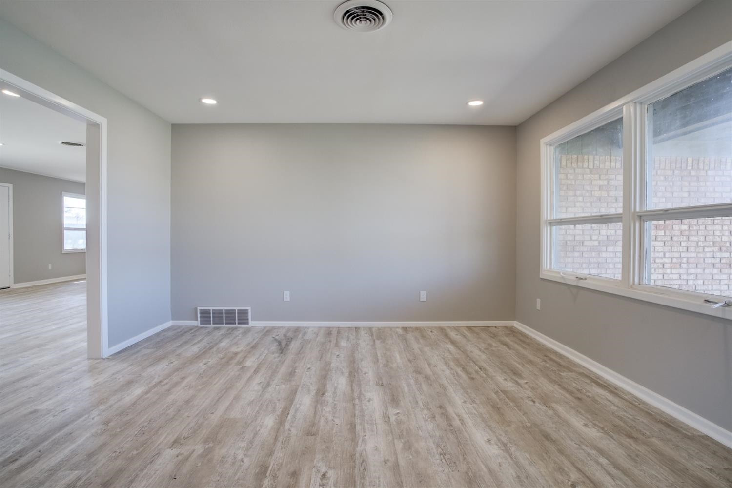 2113 66th Street Lubbock, TX 79412 - Photo 26 of 44 wooden floor in an empty room with a window