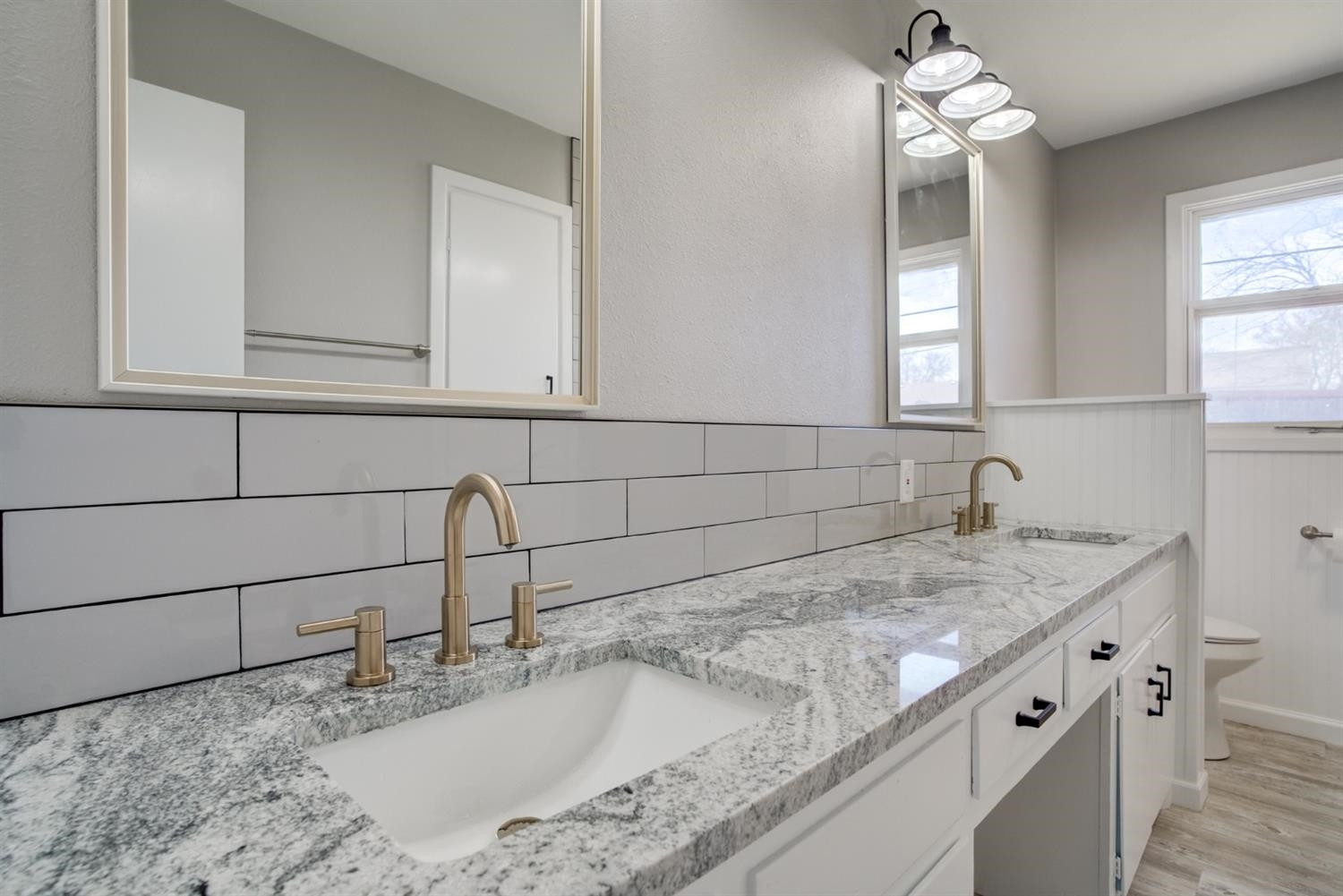 2113 66th Street Lubbock, TX 79412 - Photo 27 of 44 a kitchen with a sink and a stove top oven
