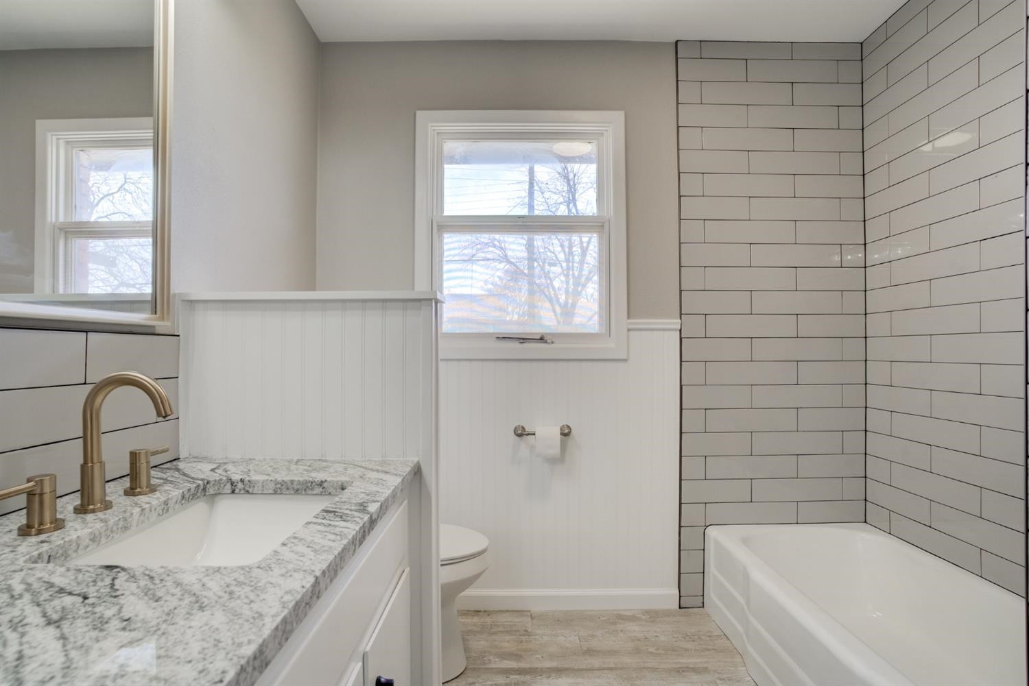 2113 66th Street Lubbock, TX 79412 - Photo 29 of 44 a bathroom with a granite countertop sink toilet and bathtub