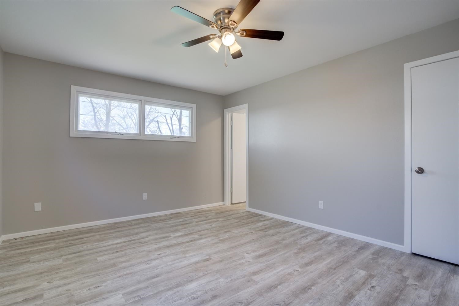 2113 66th Street Lubbock, TX 79412 - Photo 36 of 44 a view of an empty room with window and wooden floor