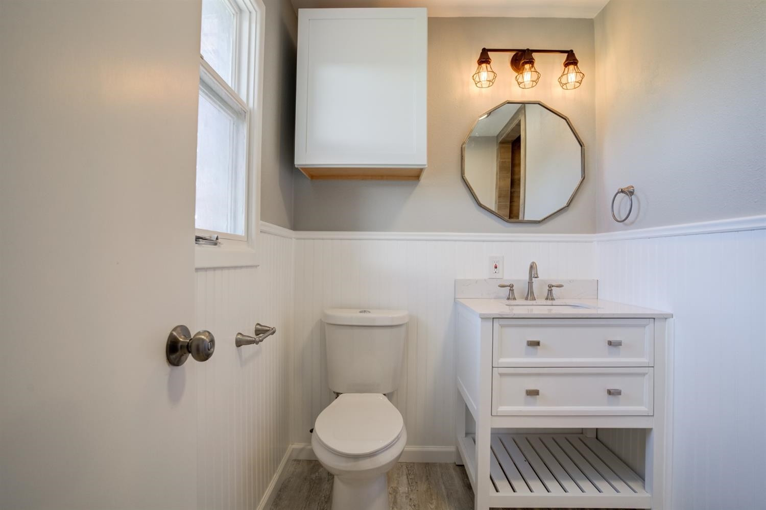 2113 66th Street Lubbock, TX 79412 - Photo 37 of 44 a bathroom with a toilet a sink and mirror