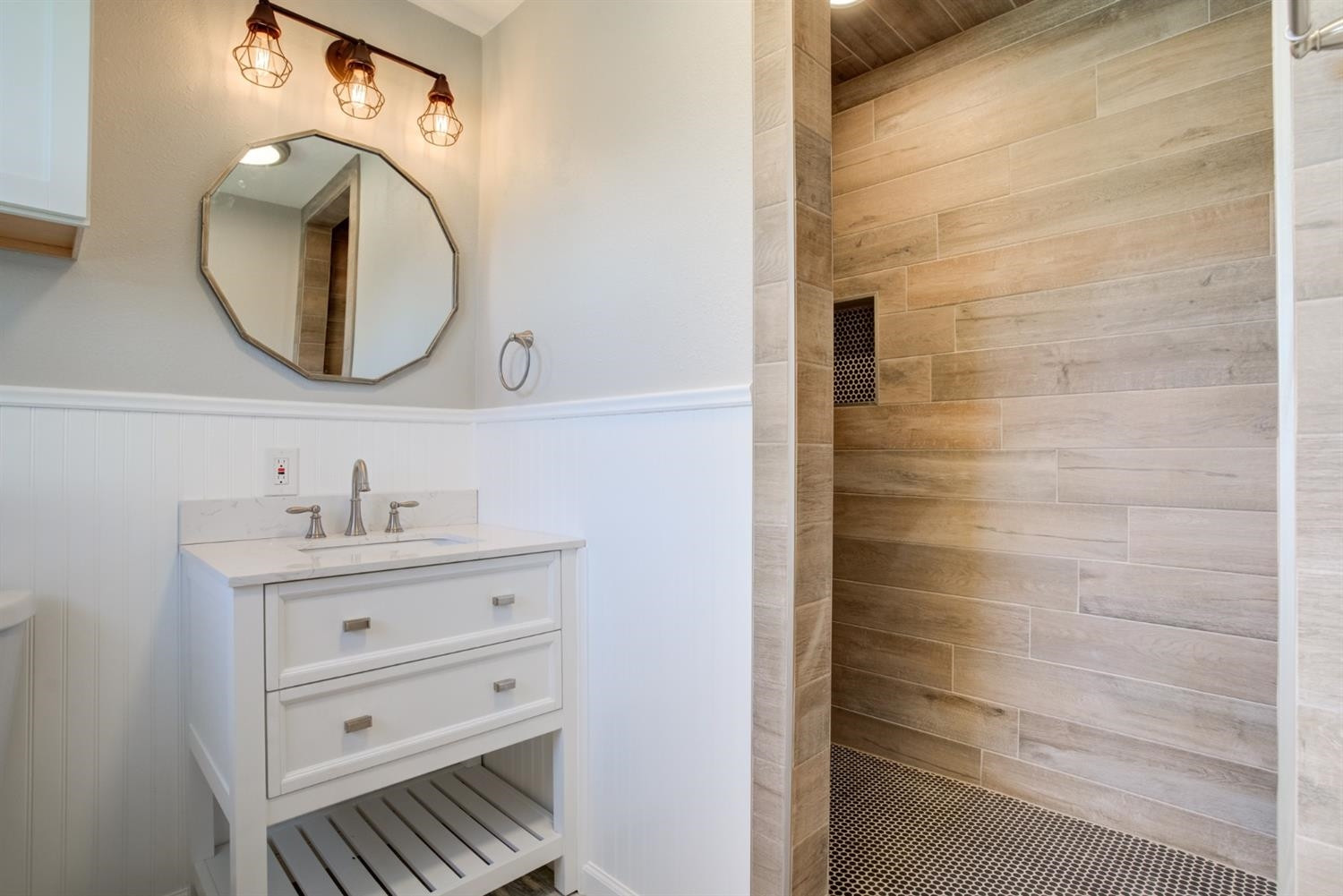 2113 66th Street Lubbock, TX 79412 - Photo 38 of 44 a bathroom with a mirror and a sink