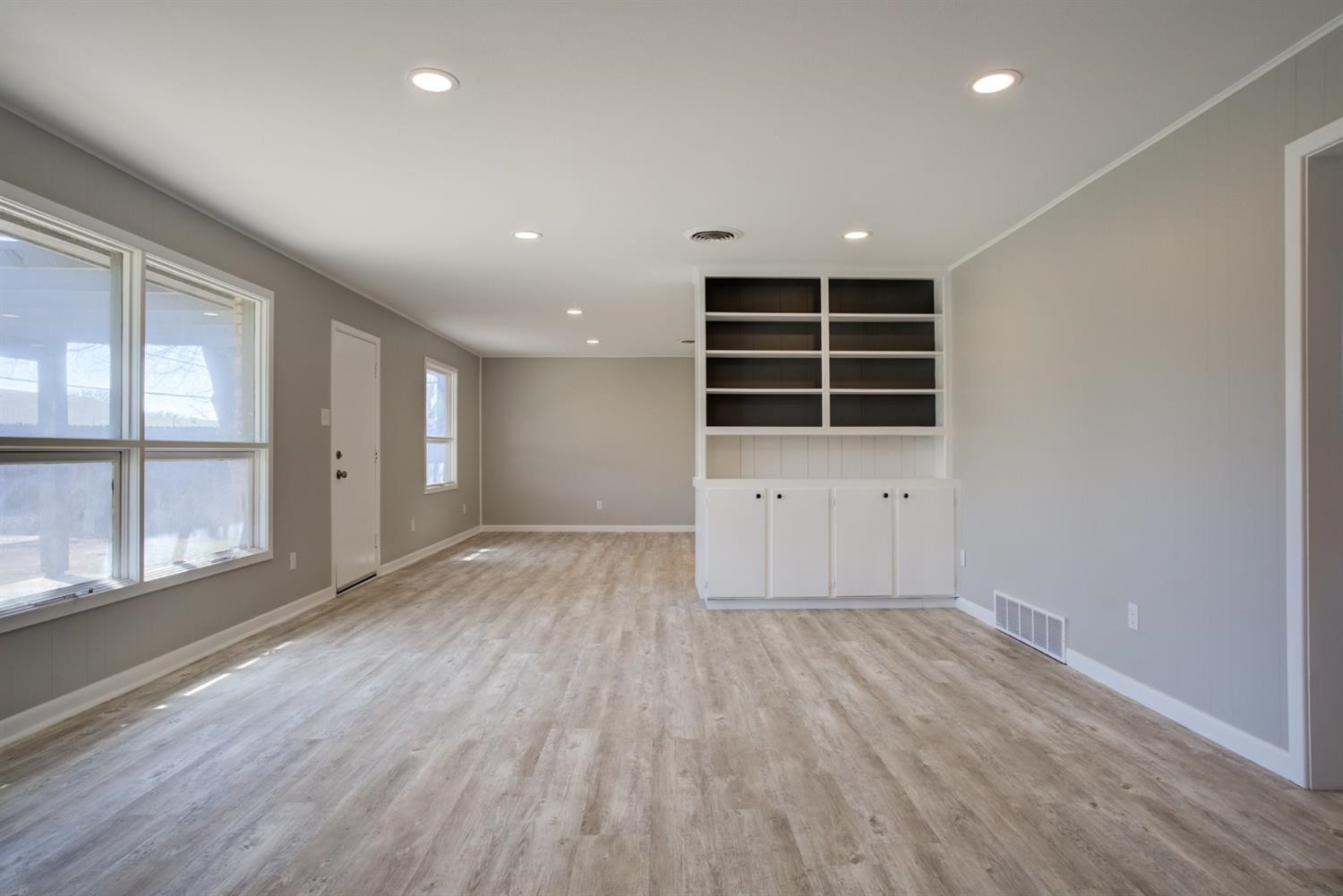 2113 66th Street Lubbock, TX 79412 - Photo 5 of 44 an empty room with wooden floor and windows