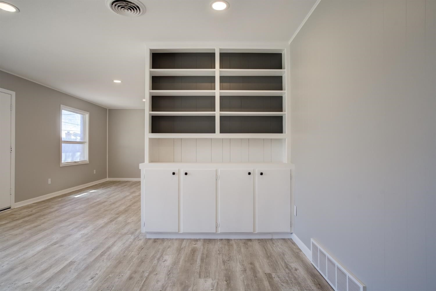 2113 66th Street Lubbock, TX 79412 - Photo 6 of 44 wooden floor in an empty room with a window