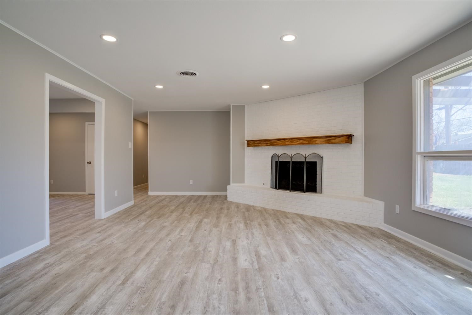 2113 66th Street Lubbock, TX 79412 - Photo 8 of 44 an empty room with wooden floor and a window