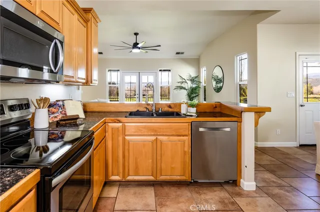 a kitchen with a sink appliances and cabinets