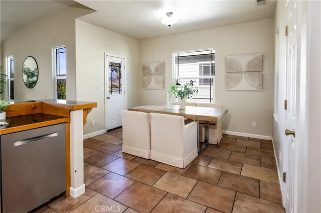 a view of a kitchen with fridge and wooden floor