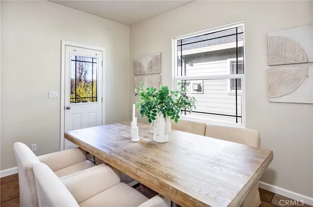 a dining room with furniture and wooden floor