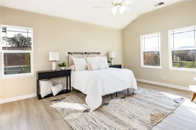 a bed sitting in a bedroom next to a window