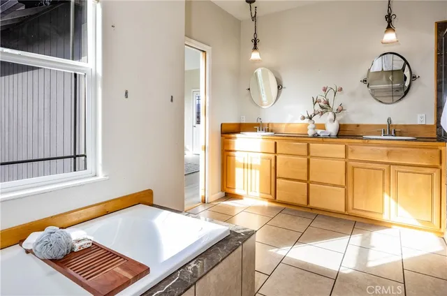 a spacious bathroom with a sink and a mirror