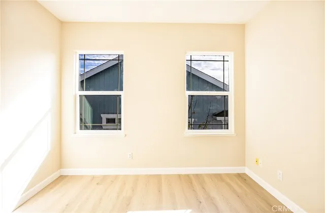 a view of a hallway with wooden floor and entryway