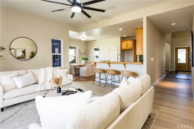 a living room with furniture a clock and a chandelier