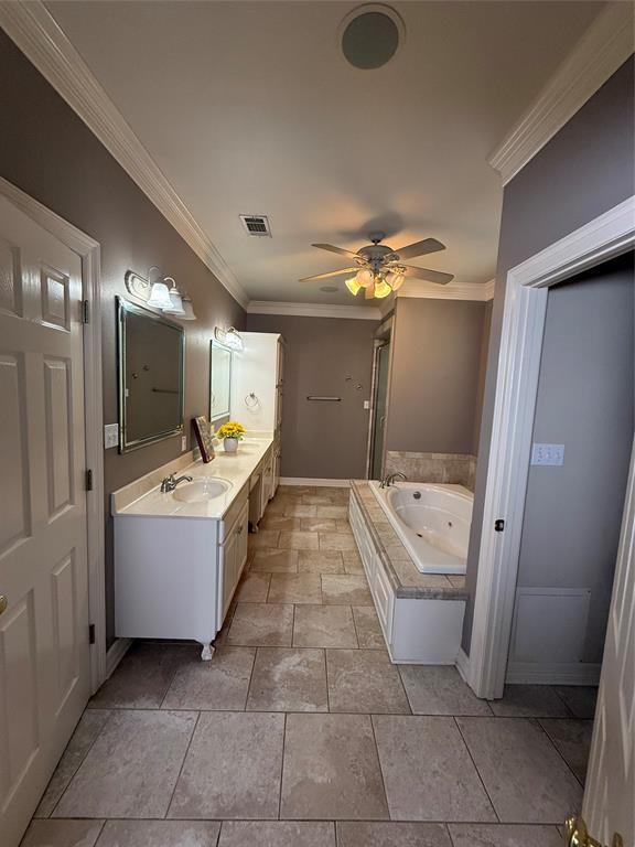 201 Woodhaven Drive Minden, LA 71055 - Photo 13 of 31 Spacious bathroom featuring tiled flooring, a dual vanity with undermount sinks, and a built-in jetted tub