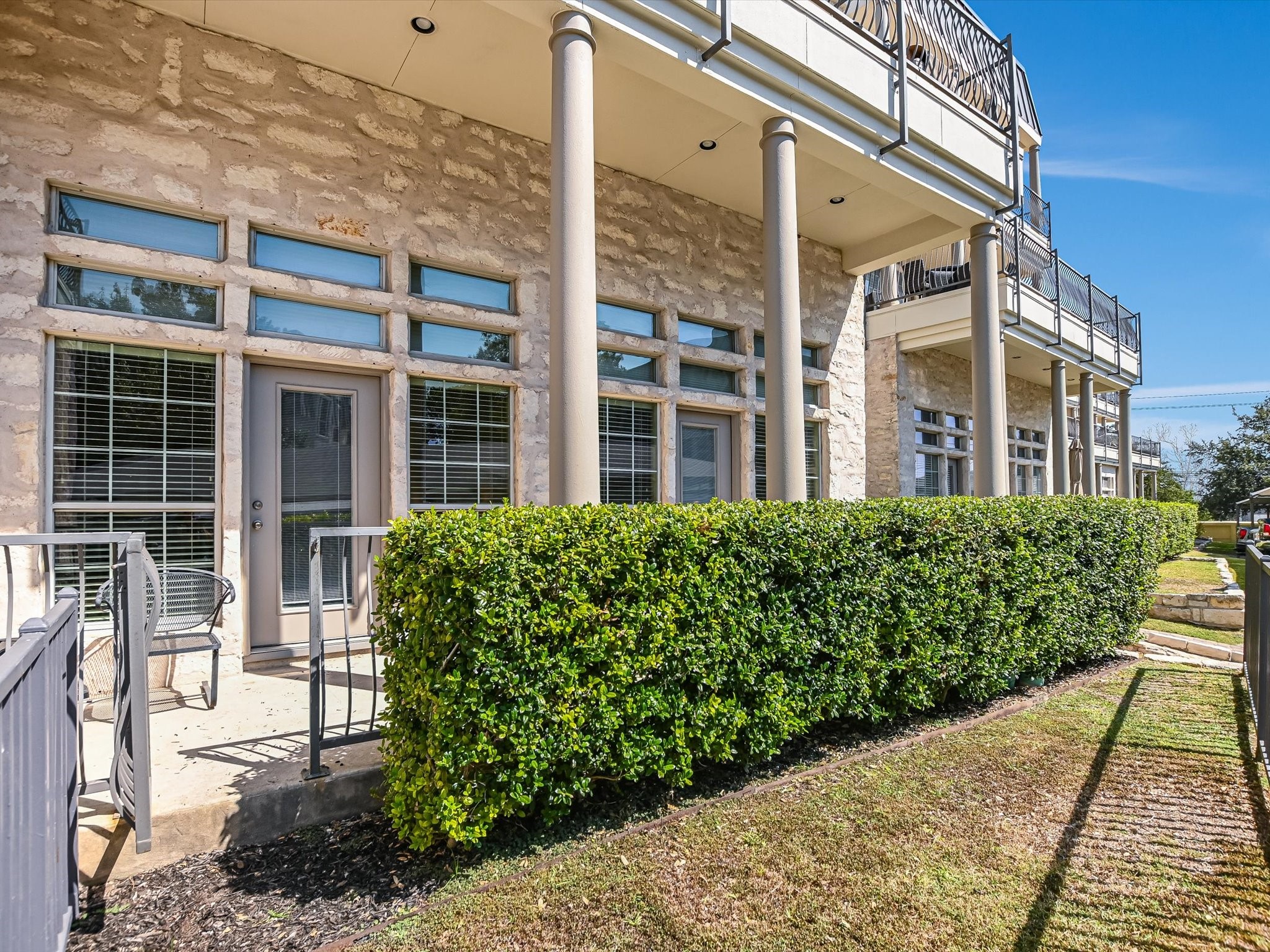 2918 Ranch Road 620 North, Unit X205 Austin, TX 78734 - Photo 15 of 23 a front view of a building with a garden
