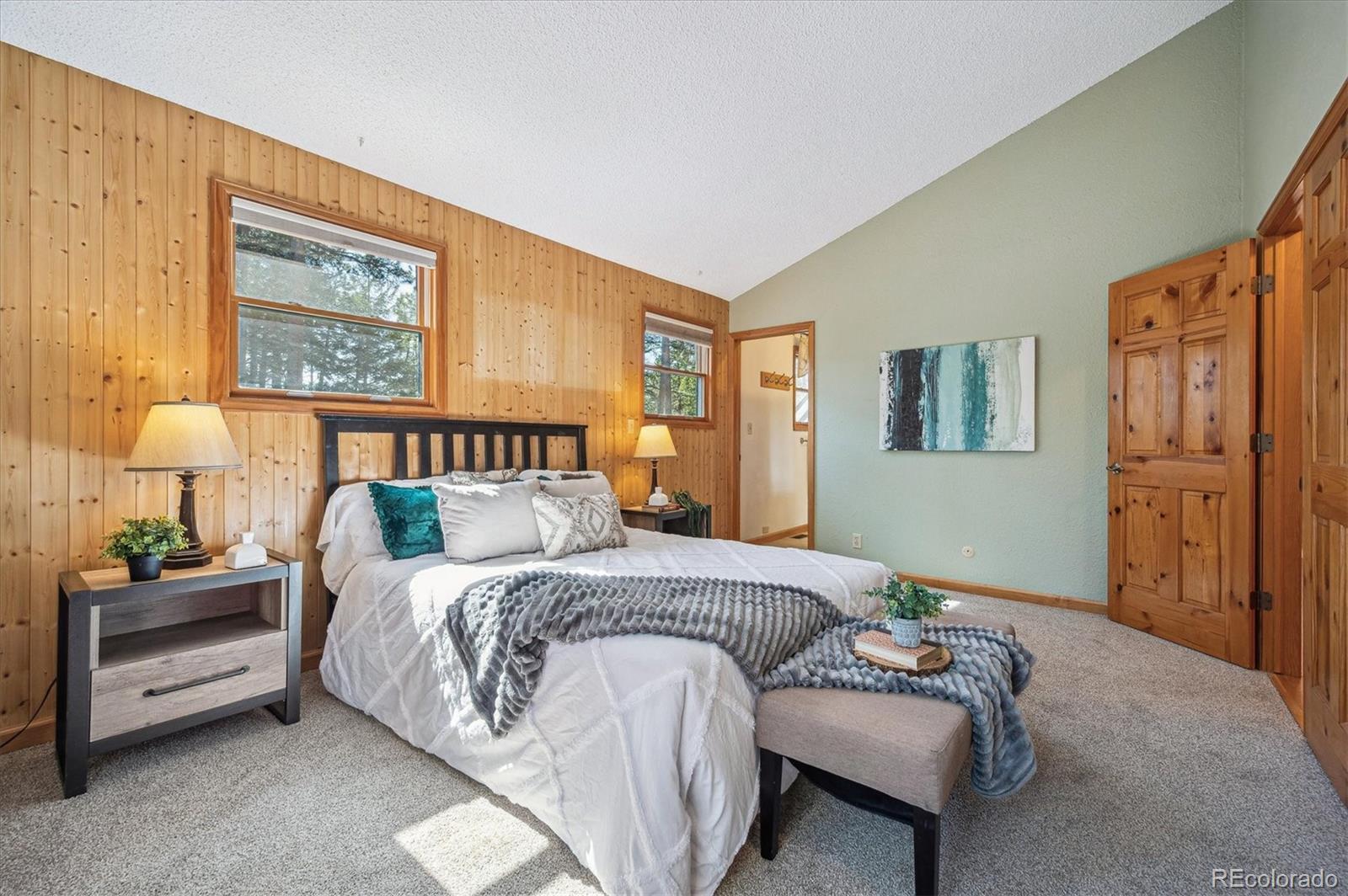20025 Flint Lane Morrison, CO 80465 - Photo 13 of 35 a bedroom with a bed and a night stand