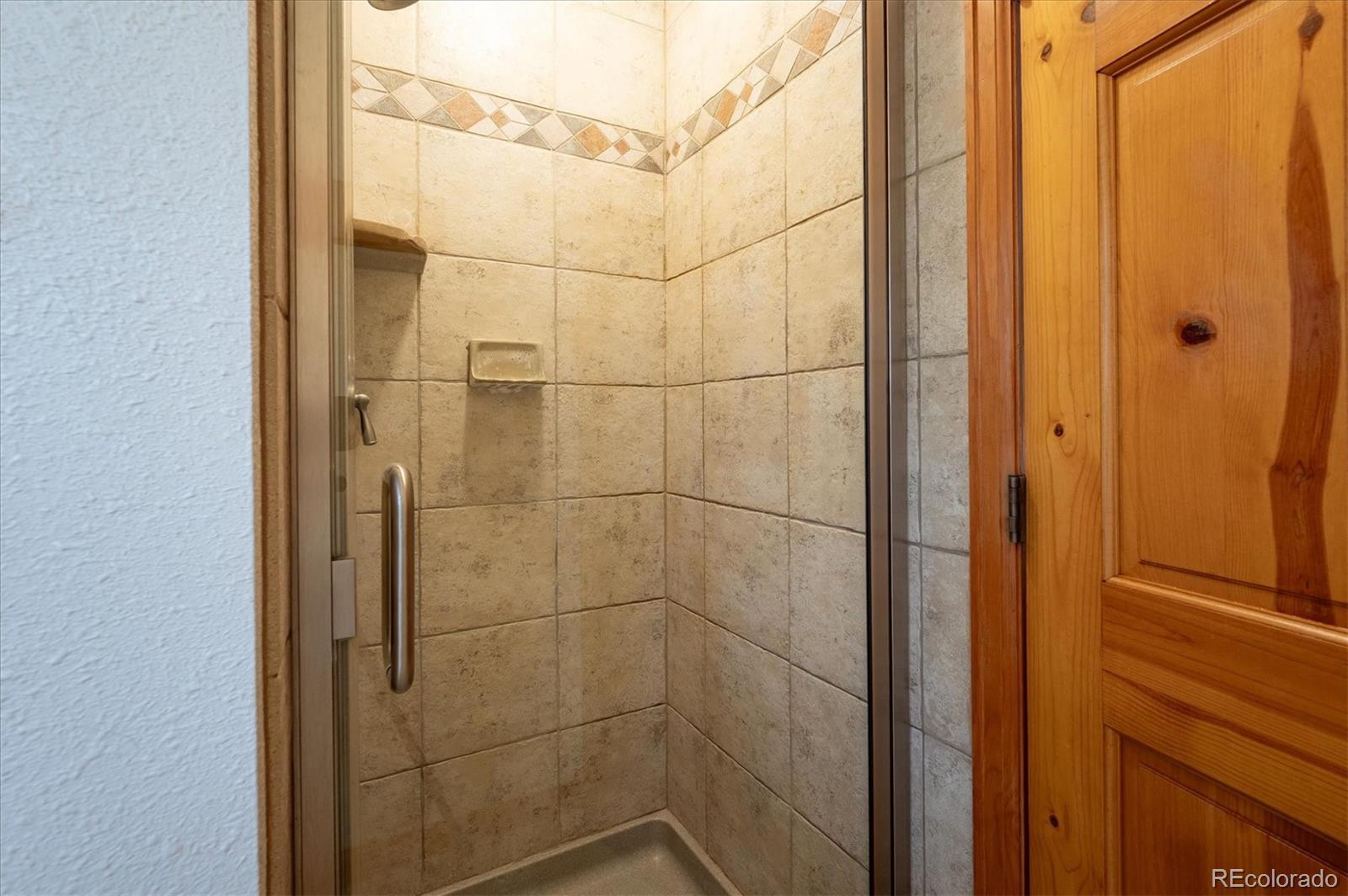 20025 Flint Lane Morrison, CO 80465 - Photo 17 of 35 a bathroom with a shower