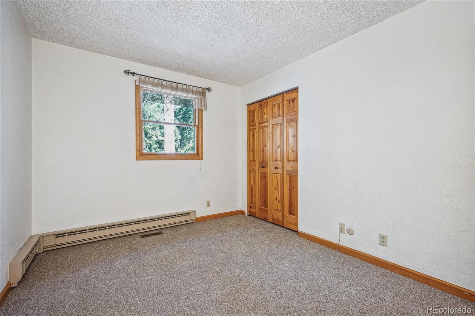 20025 Flint Lane Morrison, CO 80465 - Photo 19 of 35 an empty room with windows