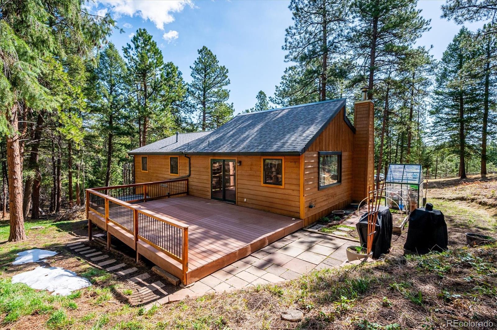 20025 Flint Lane Morrison, CO 80465 - Photo 28 of 35 a front view of a house with a yard