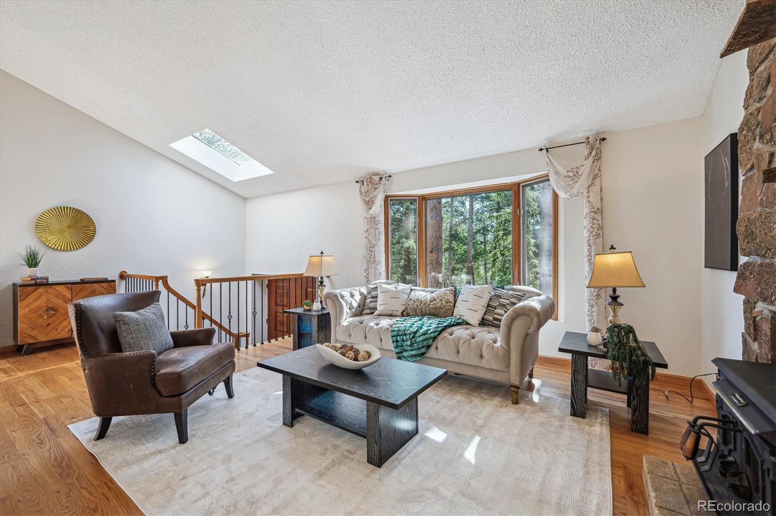 20025 Flint Lane Morrison, CO 80465 - Photo 4 of 35 a living room with furniture and a large window