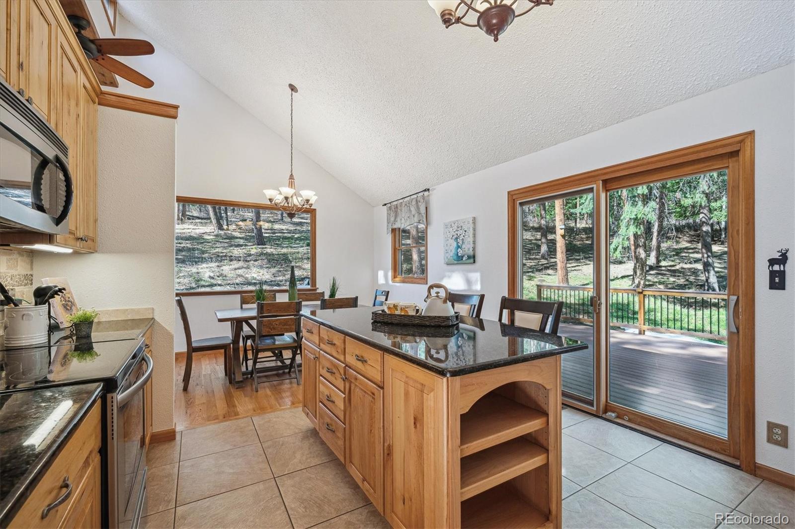 20025 Flint Lane Morrison, CO 80465 - Photo 10 of 35 a kitchen with stainless steel appliances granite countertop a stove a sink and a refrigerator