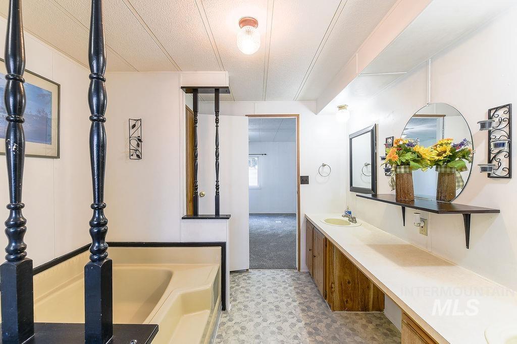 609 North Almon Street, Unit 2011 Moscow, ID 83843 - Photo 34 of 45 Full bath featuring double vanity, a bath, and light flooring
