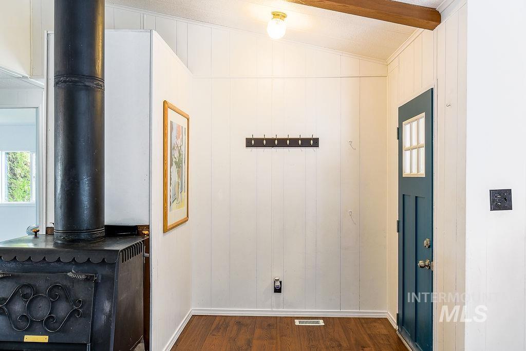 609 North Almon Street, Unit 2011 Moscow, ID 83843 - Photo 6 of 45 Detailed view of wood finished floors, wooden walls, and a wood stove