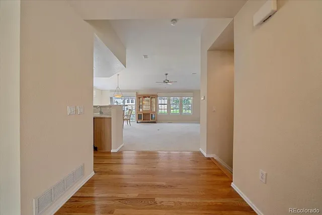a view of a hallway with wooden floor