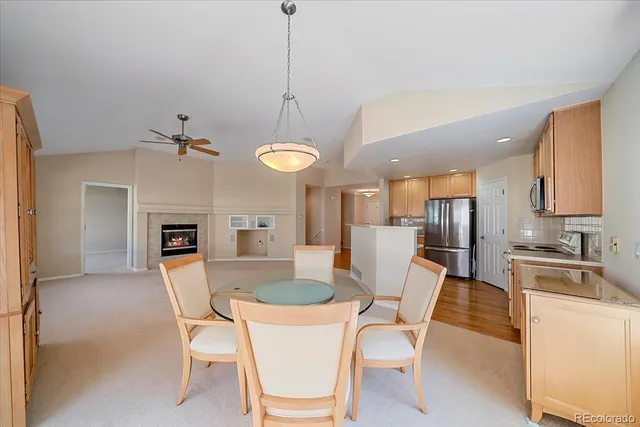 a dining room with furniture a chandelier and kitchen view