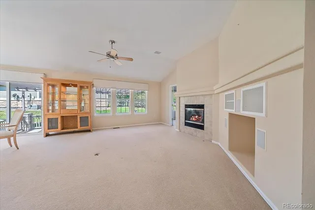 an empty room with furniture and a fireplace