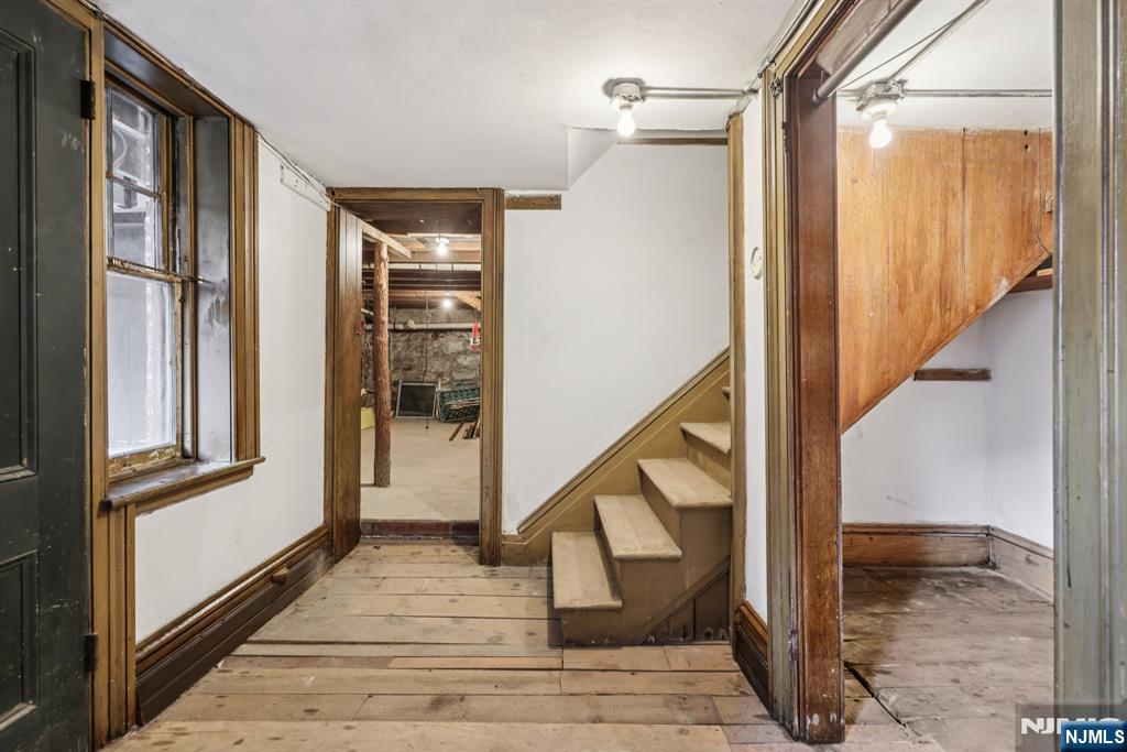 142 Island Road Mahwah, NJ 07430 - Photo 13 of 21 a view of staircase with wooden floor and chair