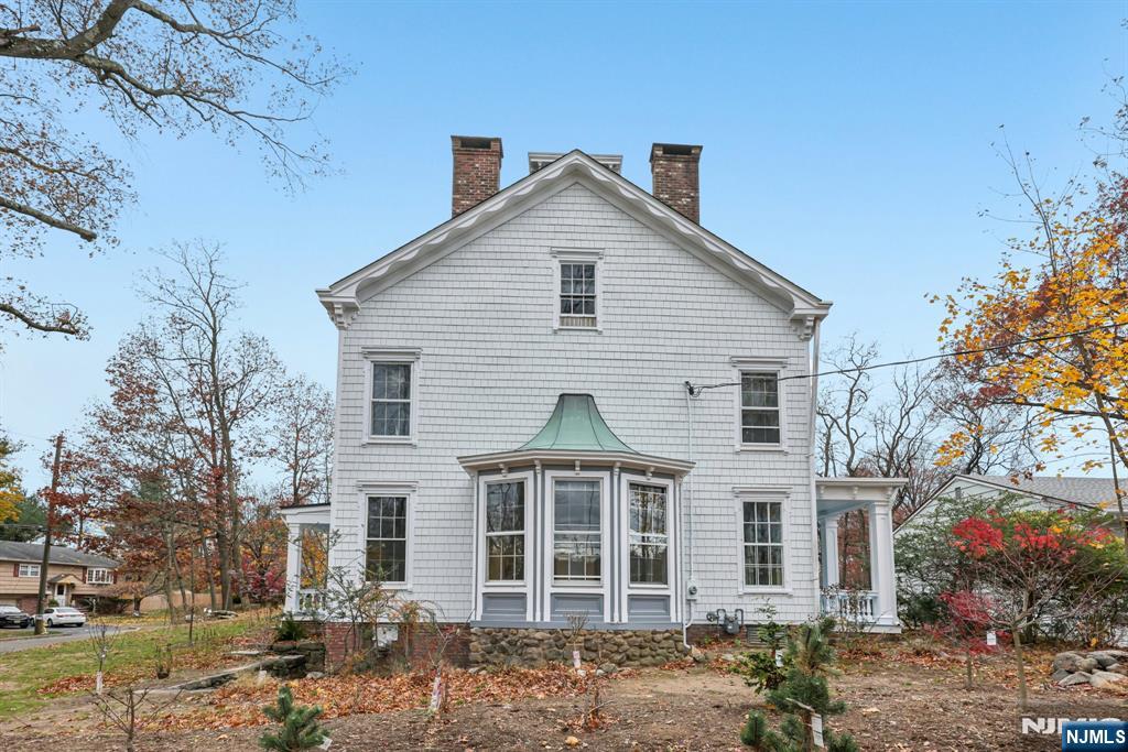 142 Island Road Mahwah, NJ 07430 - Photo 18 of 21 a view of a white house next to a yard with large trees