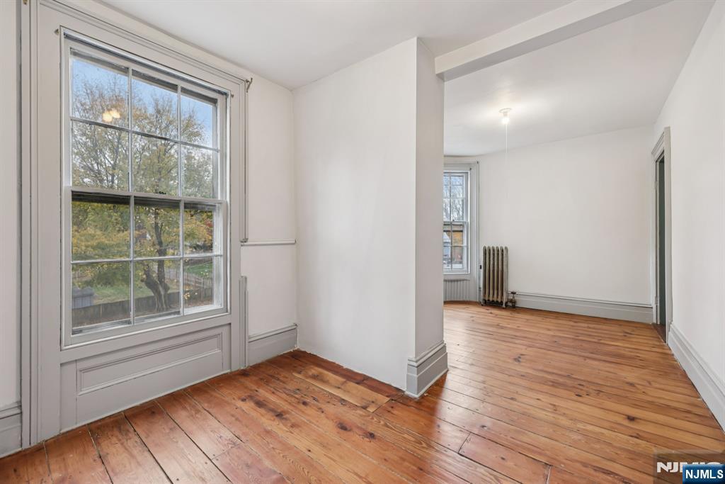 142 Island Road Mahwah, NJ 07430 - Photo 3 of 21 a view of an empty room with wooden floor and a window
