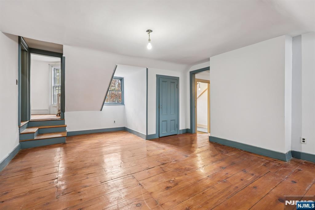 142 Island Road Mahwah, NJ 07430 - Photo 7 of 21 an empty room with wooden floor and windows