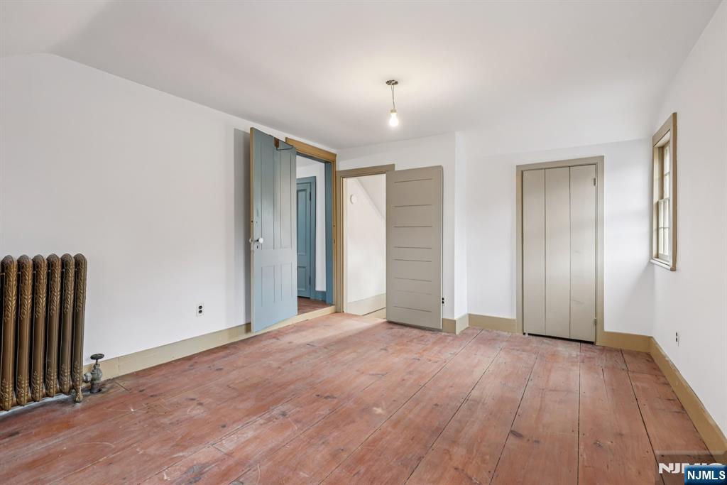 142 Island Road Mahwah, NJ 07430 - Photo 9 of 21 an empty room with wooden floor and windows