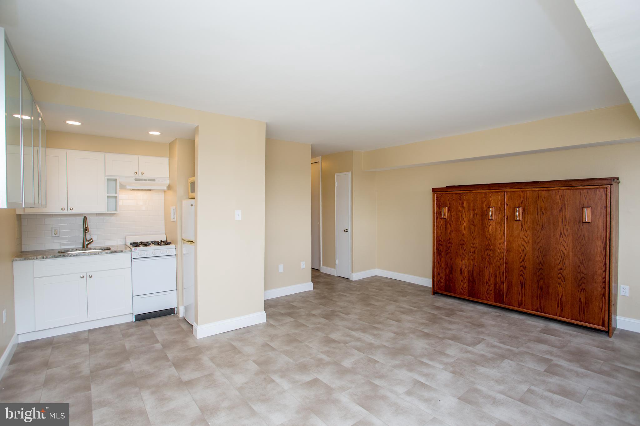 2101-17 Chestnut Street, Unit 1809 Philadelphia, PA 19103 - Photo 14 of 38 an empty room with a cabinet and mirrors