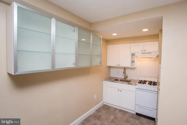 a room with a sink and cabinets