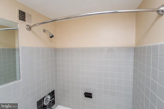 a bathroom with a shower and a shower head