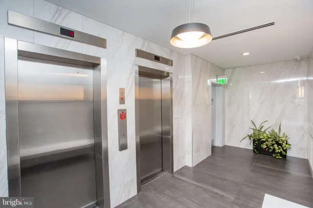 a view of a hallway with wooden shelves