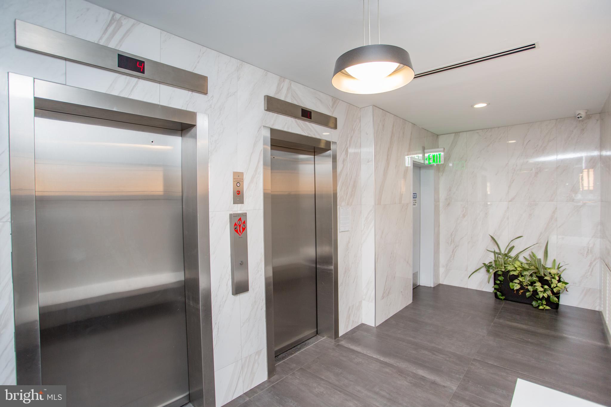 2101-17 Chestnut Street, Unit 1809 Philadelphia, PA 19103 - Photo 7 of 38 a view of a hallway with wooden shelves