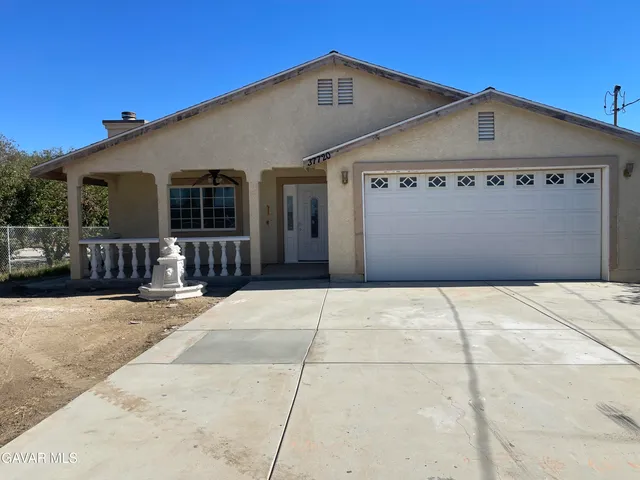 a view of a house with a fence