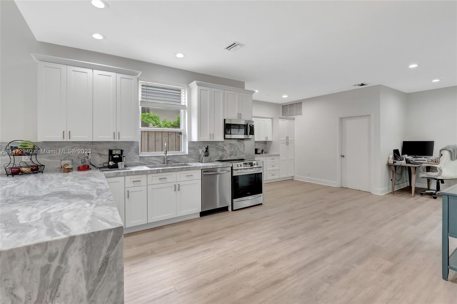 6636 Northwest 25th Avenue Boca Raton, FL 33496 - Photo 22 of 96 a large kitchen with stainless steel appliances granite countertop a stove a sink and a refrigerator