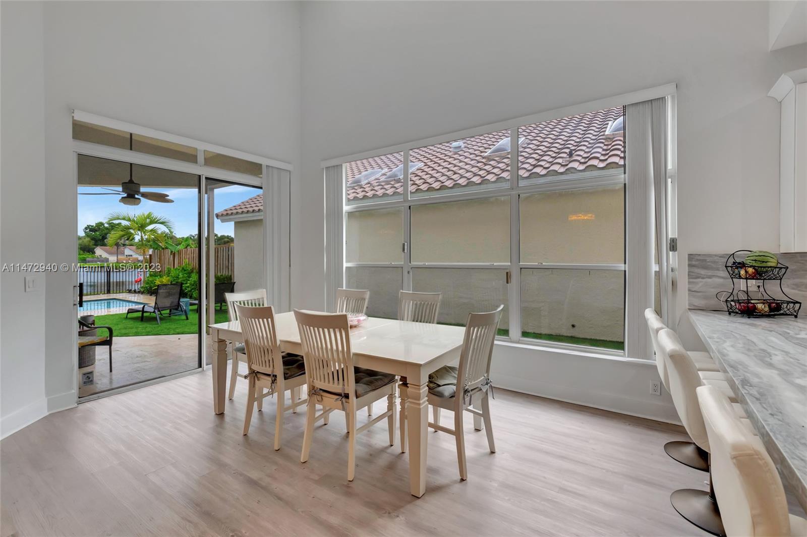 6636 Northwest 25th Avenue Boca Raton, FL 33496 - Photo 30 of 96 a view of a dining room with furniture and a window