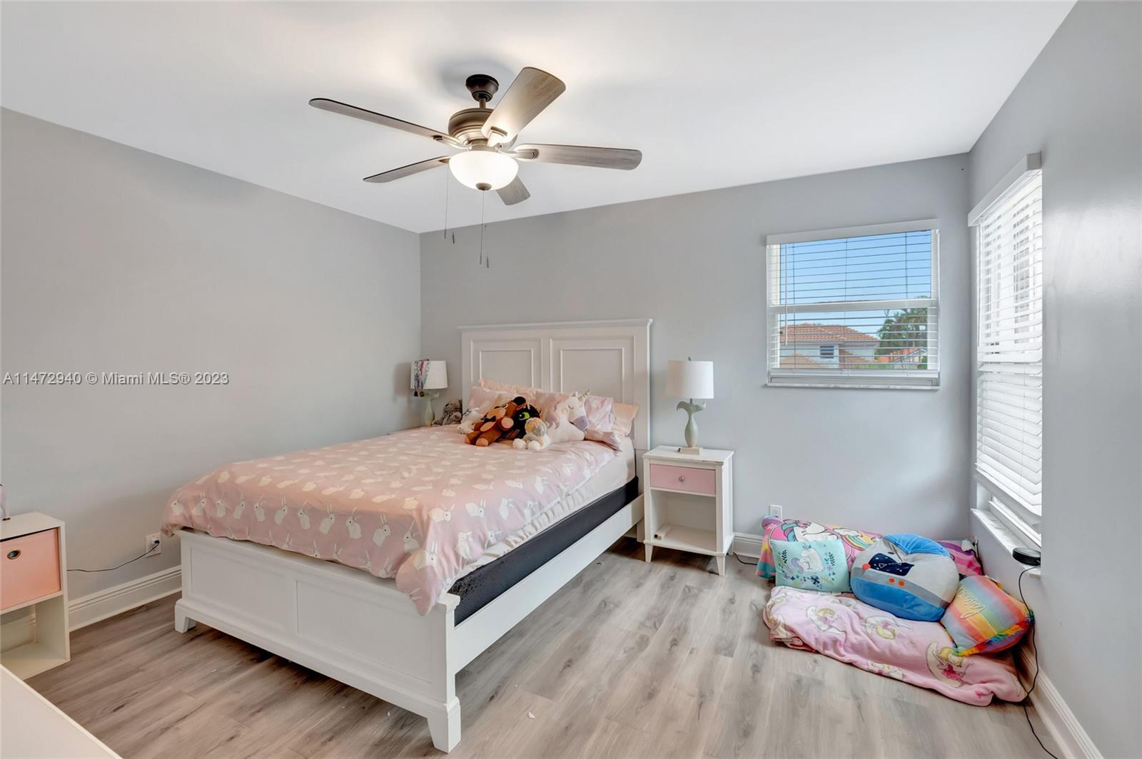 6636 Northwest 25th Avenue Boca Raton, FL 33496 - Photo 38 of 96 a bed room with a bed and a chandelier