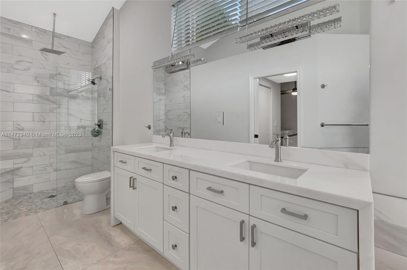 6636 Northwest 25th Avenue Boca Raton, FL 33496 - Photo 40 of 96 a bathroom with a double vanity sink a toilet and a shower