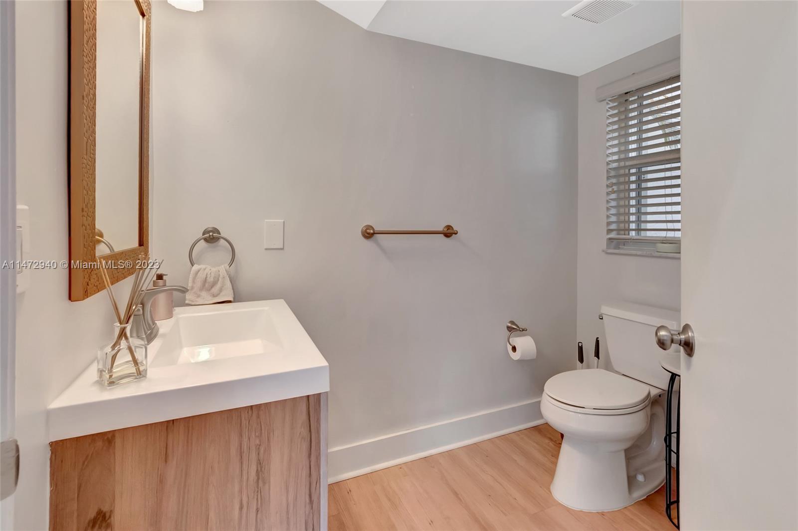 6636 Northwest 25th Avenue Boca Raton, FL 33496 - Photo 50 of 96 a bathroom with a sink toilet and a mirror