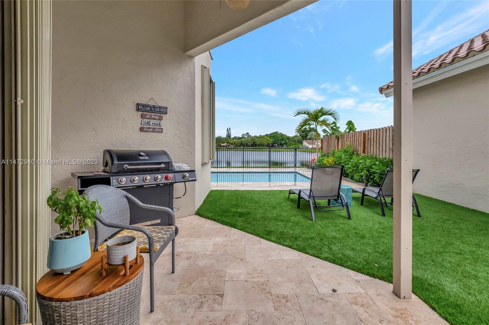 6636 Northwest 25th Avenue Boca Raton, FL 33496 - Photo 52 of 96 a view of a chair and table in the garden and yard