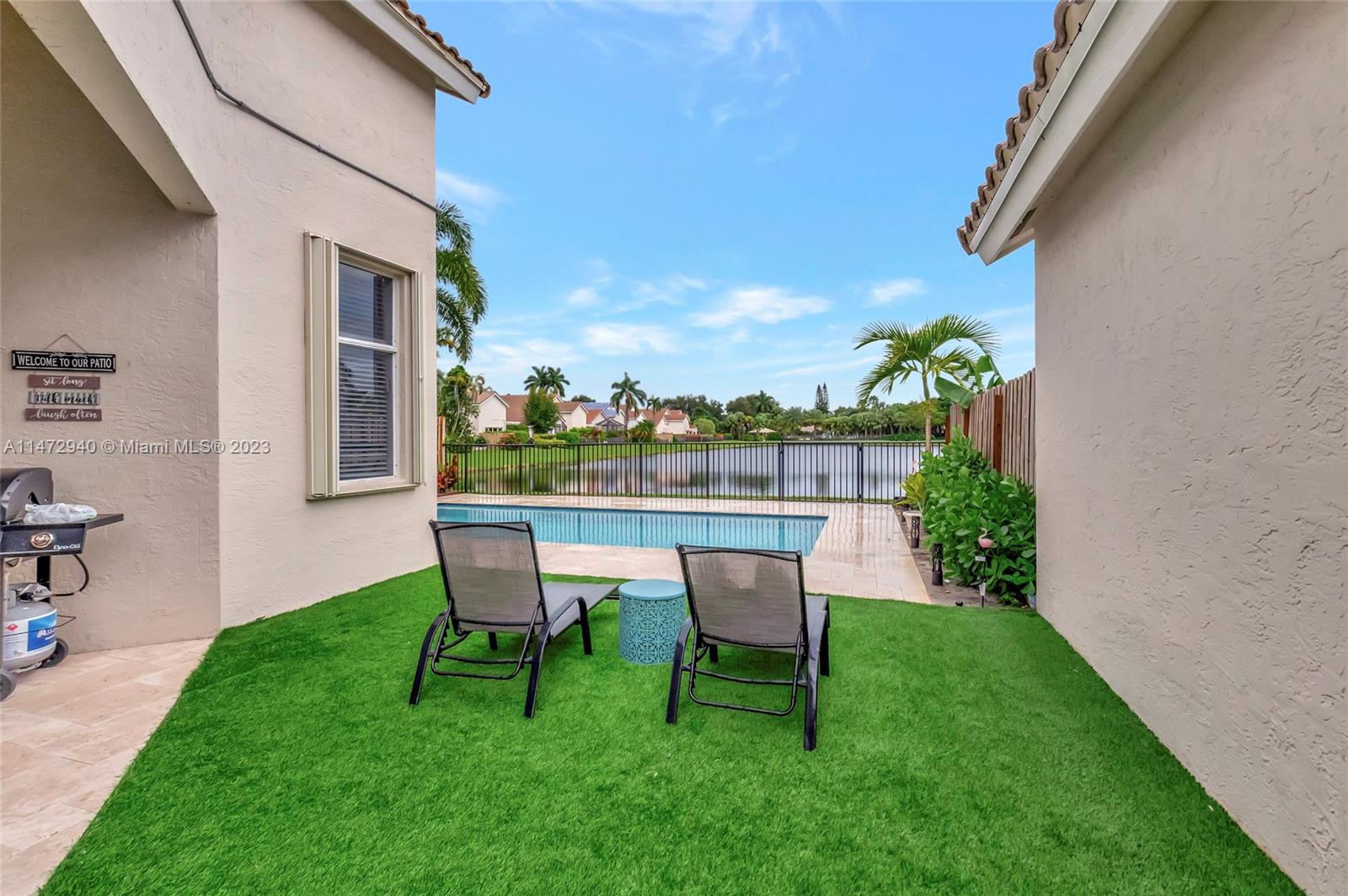 6636 Northwest 25th Avenue Boca Raton, FL 33496 - Photo 53 of 96 a view of a chair and table in backyard of the house